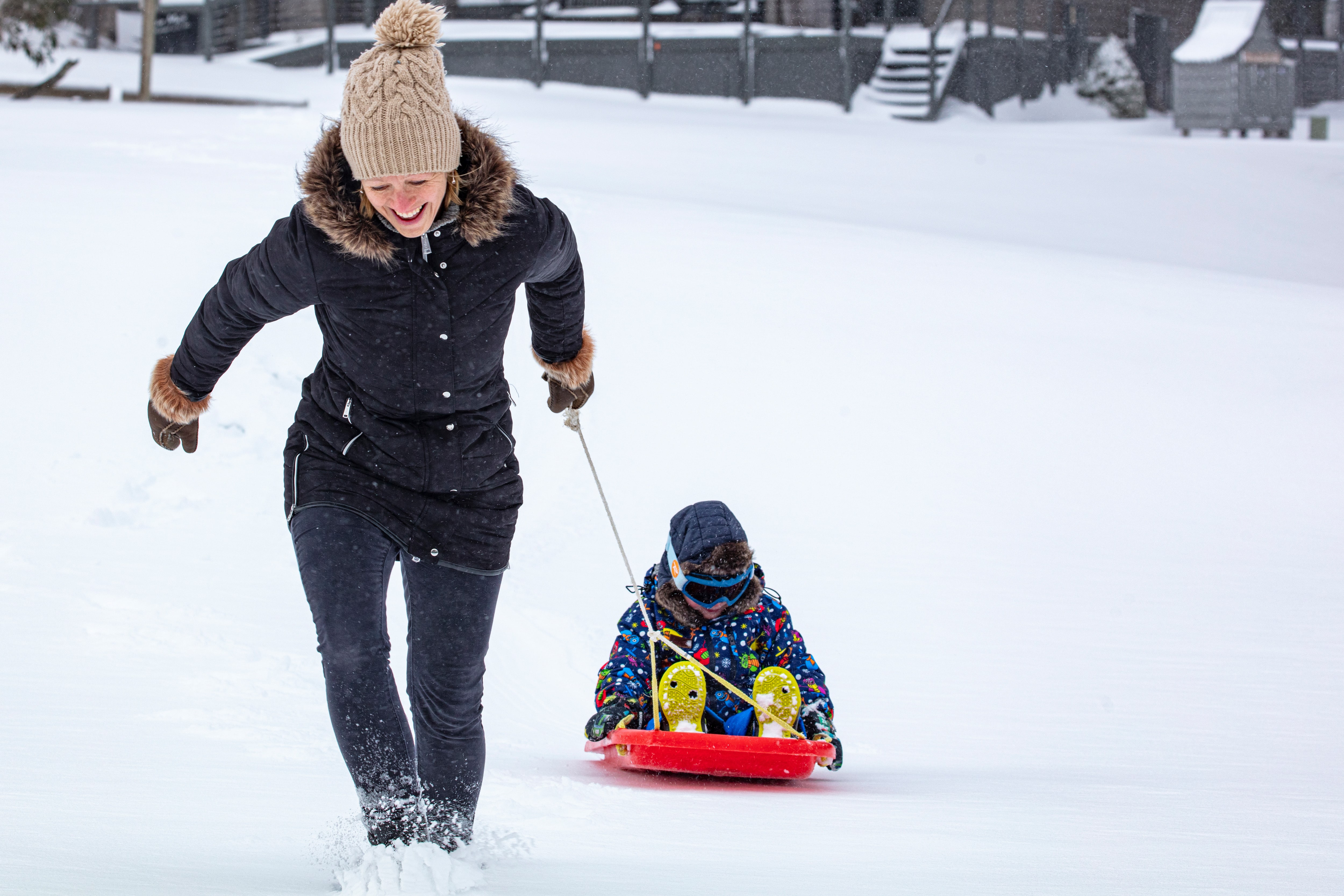 Tobogganing parent with child