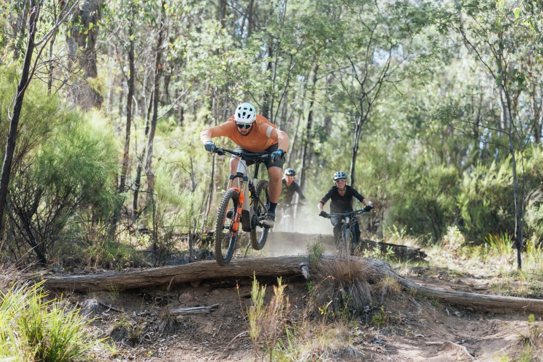A group of riders taking on technical features at Big Hill Mountain Bike Park